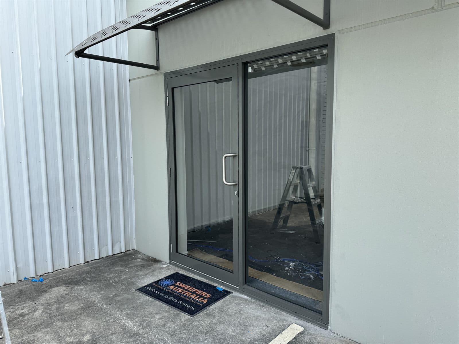 New business glass swing door and fixed panel installation